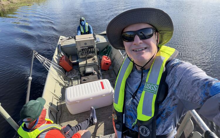USGS crew stand and sit in a boat during the May 2026 Fish Slam