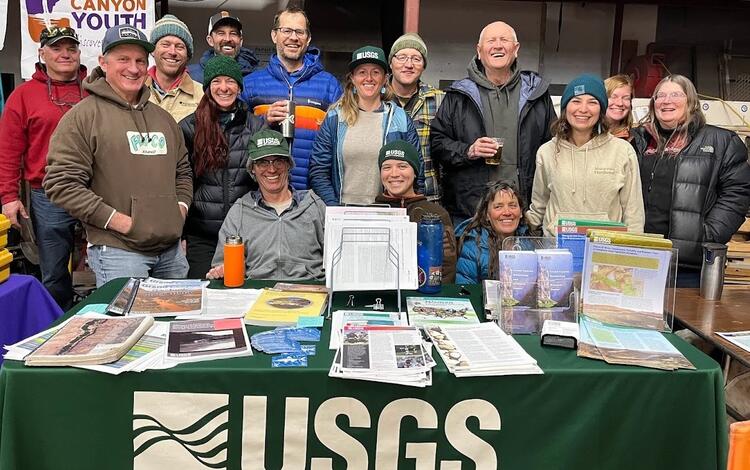 Grand Canyon Monitoring and Research Center staff at the USGS table during the Grand Canyon River Guides training, 2024