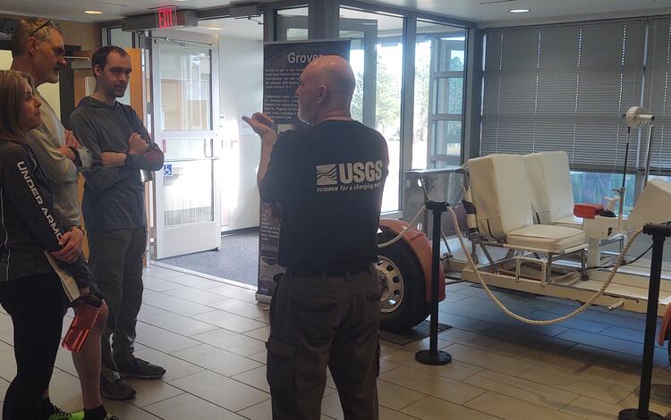 Greg Vaughn at USGS Astrogeology talks to visitors at the 2023 USGS Open House