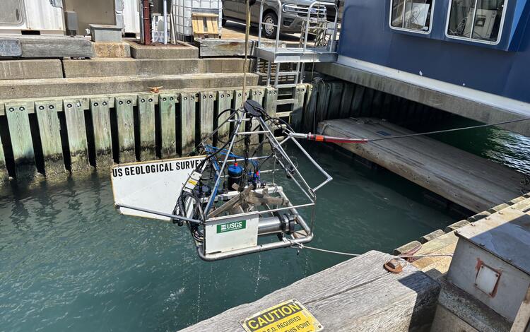 Equipment being lowered into the water off a dock