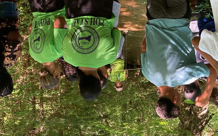 group of people in wooded area