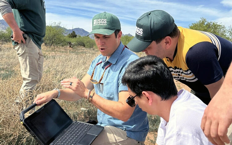 USGS staff demonstrate to Uzbek researchers the process of collecting and recording USGS groundwater data