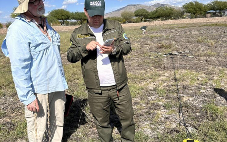 The USGS hydrologist demonstrates a new subsurface geophysics tool in the field