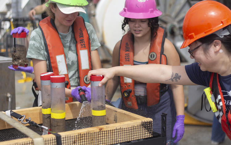 Scientists preparing push core samples during the Hawaii Abyssal Nodules Expedition