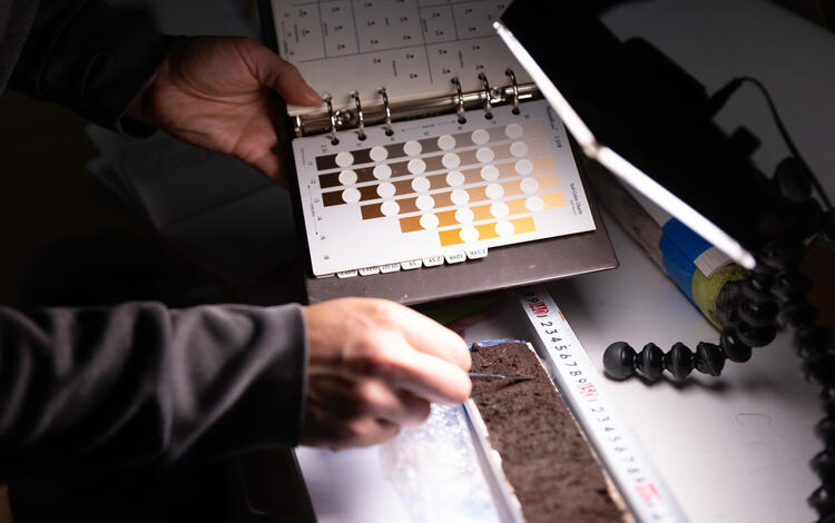 Scientists analyzing material extracted from sediment cores