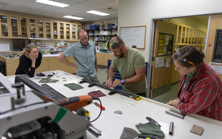 Scientists separating a sediment core split lengthwise