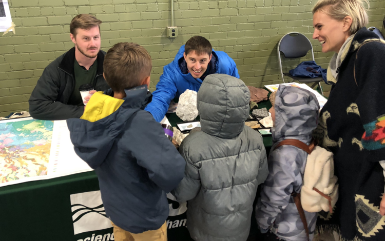 Geology, Minerals, Energy, Geophysics Science Center (GMEG) staff display rocks and maps and talk to kids at the STEM event