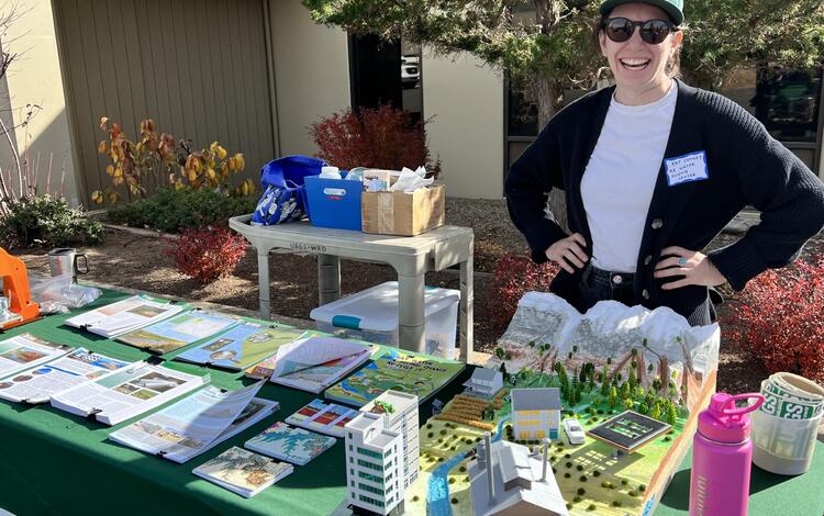 Kat Cooney stands in front of an outreach table on the Flagstaff USGS campus