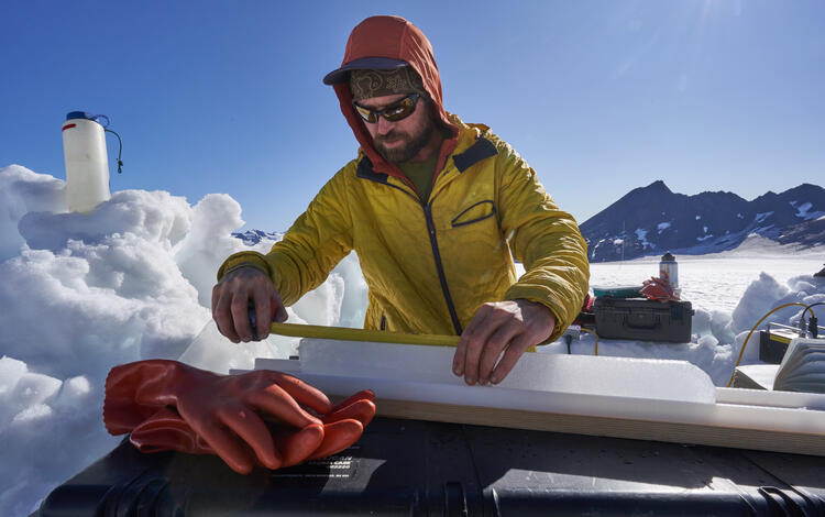 USGS scientist, measures and weighs an ice core extracted from Wolverine Glacier.