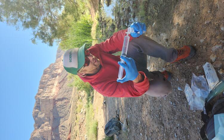 Zach Harrison collects a water quality sample at Willow Spring, AZ