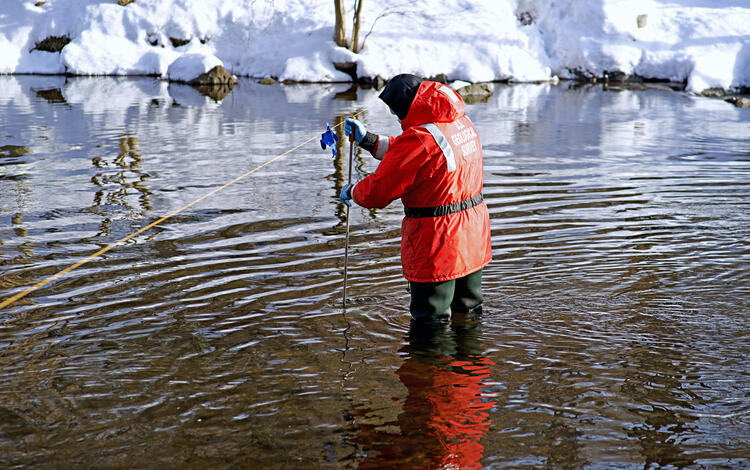 The water quality sample is being taken at Saugatuck River near Westport, CT 01209500
