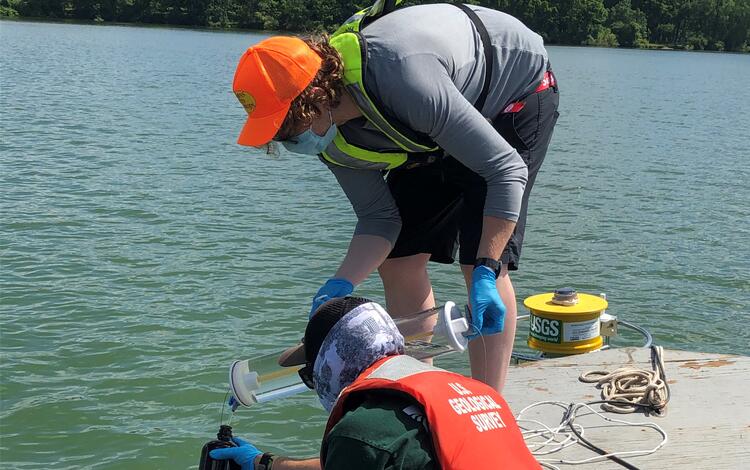 Scientists collecting water samples from near the water buoy