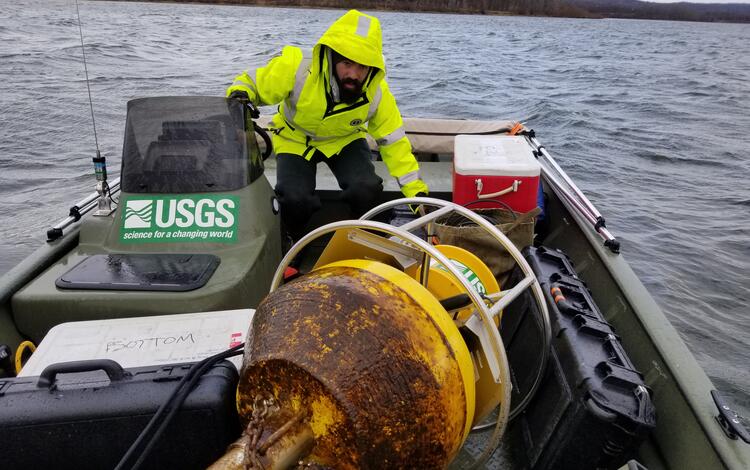 Scientist with Buoy on boat after retrieving it from the reservoir