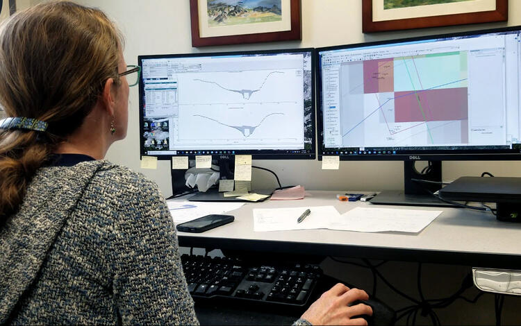 USGS employee using survey data to model water surface elevation for different storm events.
