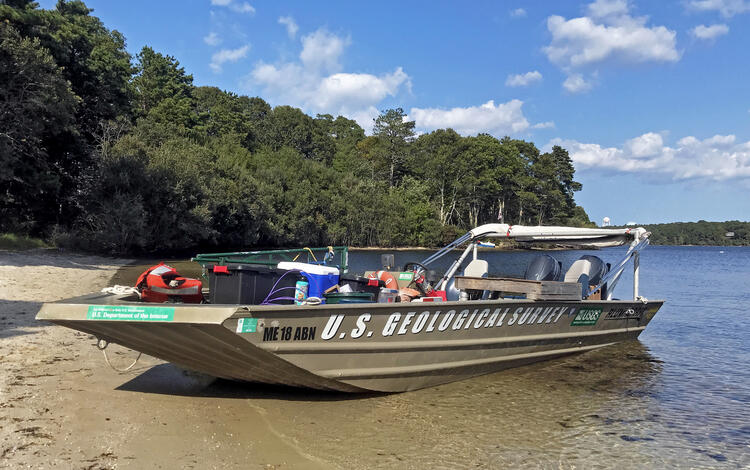 boat, blue sky, water, shore, trees