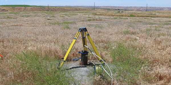 Well with water-quality sampling line being held down by tripod | U.S ...