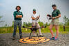 Amit Millo, Sandy Brosnahan, and Jennifer Cramer of the USGS Woods Hole Aerial Imaging and Mapping (AIM) group stand with their drone during sUAS data collection at the Darby Creek Superfund site in Darby Creek, PA