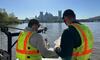 Shaun Donmoyer and Zach Houston are collecting a water sample to characterize water quality conditions near a combined sewer overflow as part of the Three Rivers Region Water Quality Monitoring with Allegheny County Sanitary Authority project