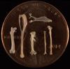 Shrew bones on top of a penny